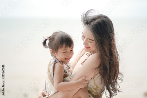 Soft and blurred portrait of asian young woman and her daughter hugging and laughing together. Lovely family concept.