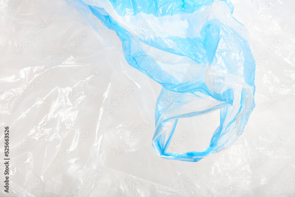 Obraz premium Plastic single use bags. Blue and white wrinkled background. Concepts: sustainability, recycling, pollution.