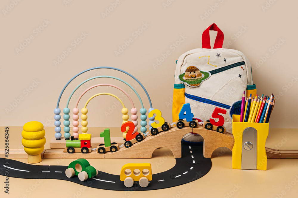 Obraz premium Colorful toys and train locomotive with numbers and Kids backpack with colour pencils. Educational game. Learning to count through play. Early education, peschool concept