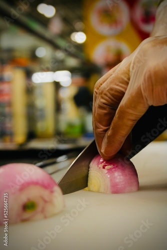 Vertical shot of a hand chopping onion photo