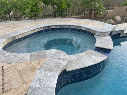 A travertine tile spa and pool remodel.