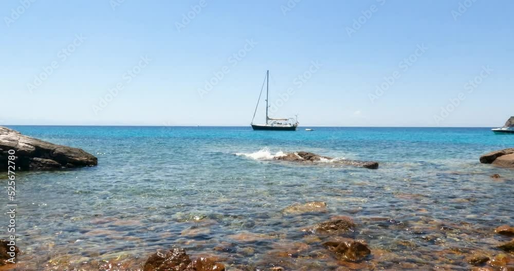 Amazing view of clear turquoise color of sea, seascape with yacht at bay, pleasure of sailing. Clear blue sky on a sunny day. Summer travel holidays concept. Slow motion 4K footage. Amazing view of clear turquoise color of sea, seascape with yacht at bay, pleasure of sailing. Clear blue sky on a sunny day. Summer travel holidays concept. Slow motion 4K footage.