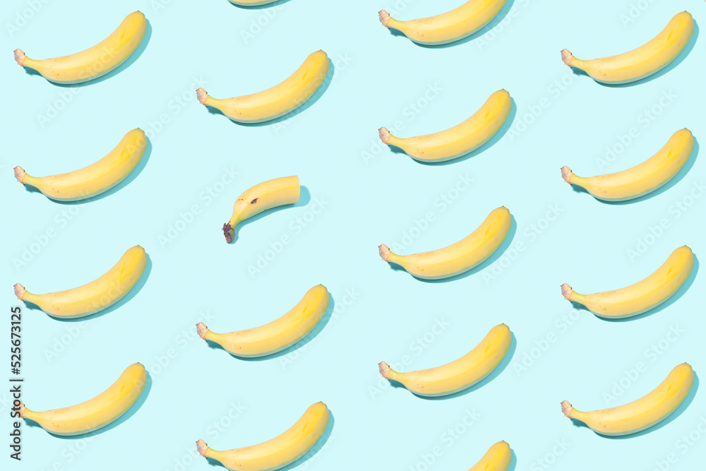 Creative pattern of whole bananas and one half of a banana - a concept on the theme of 