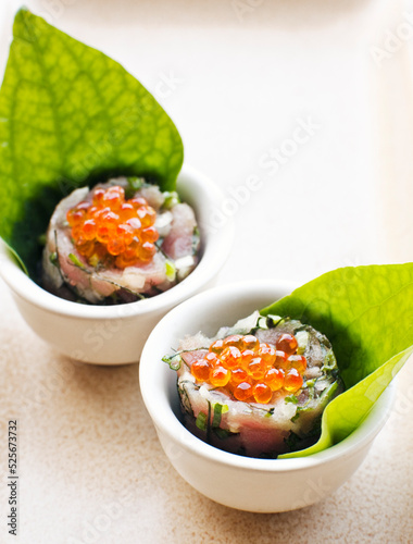 Spicy tuna tartar with lime juice, chili and roasted rice, a healthy, low-calorie Thai tapas dish. Thailand.