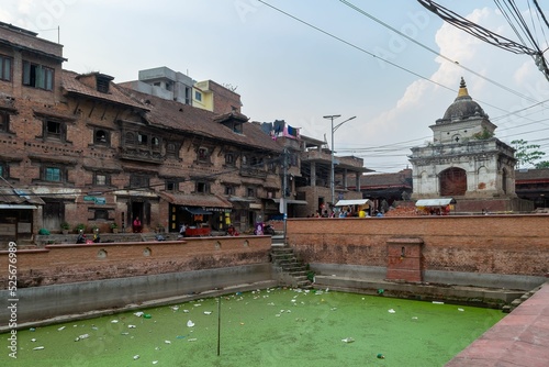 Historic De Pukhu building near green land in Kirtipur, Nepal photo