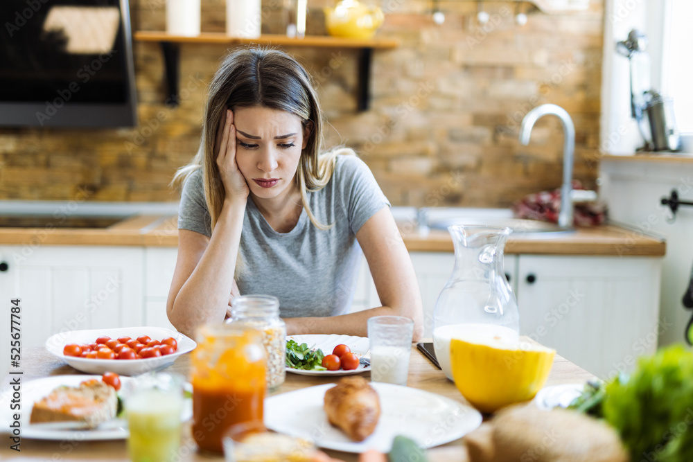 Depressed young woman doesn't want to eat her breakfast Depressed young woman doesn't want to eat her breakfast