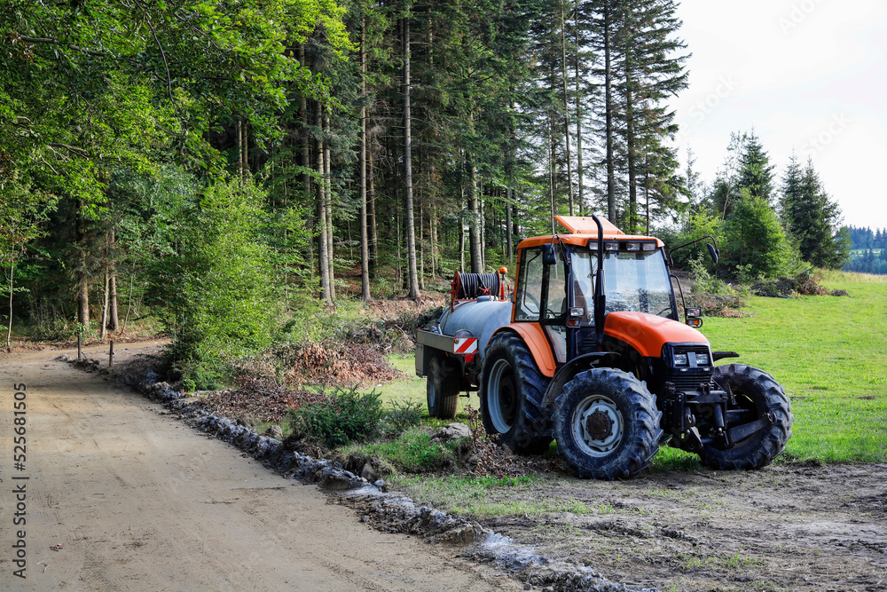 ZAKOPANE, POLAND - AUGUST 08. 2022: Tractor working on building a road through the forest. ZAKOPANE, POLAND - AUGUST 08. 2022: Tractor working on building a road through the forest.