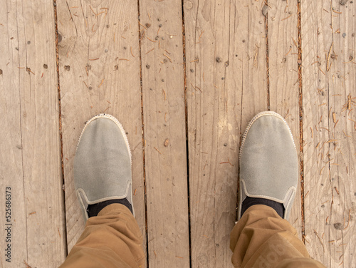 Feet on a wooden platform.