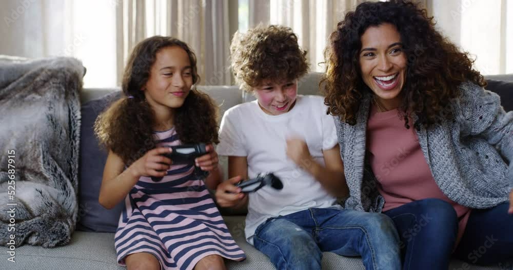 Family, game and fun of kids or siblings playing competitive console video games at home by mother. Happy, smile and children on sofa gaming together in the house with gamer boy and girl love.