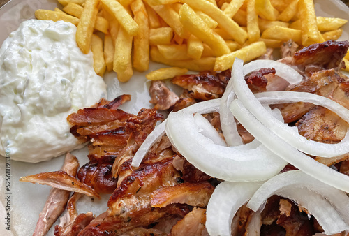 Obraz na płótnie Closeup of isolated ready to eat greek pork gyros plate with onions, french frie