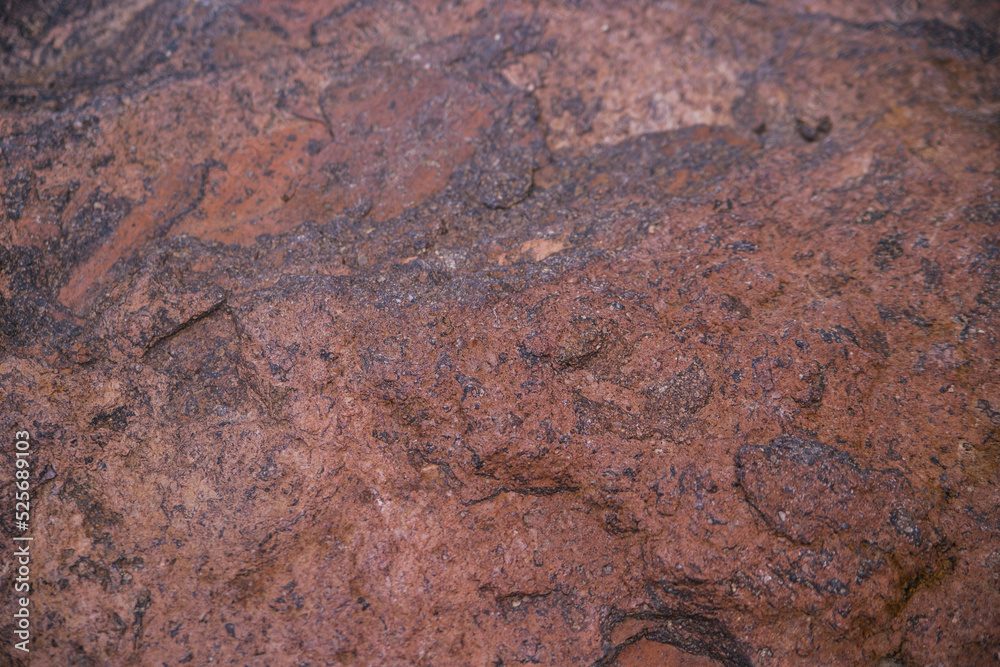Stone brown textured background. Natural stone. Uneven surface. The surface is covered with rust.