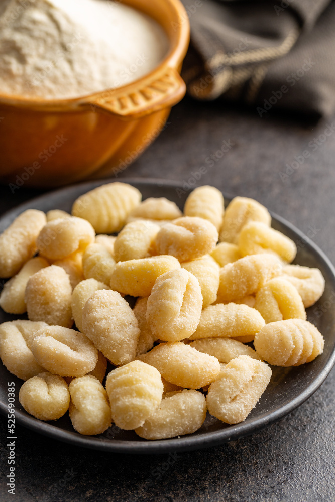 Uncooked potato gnocchi on plate. Tasty italian food. Uncooked potato gnocchi on plate. Tasty italian food.