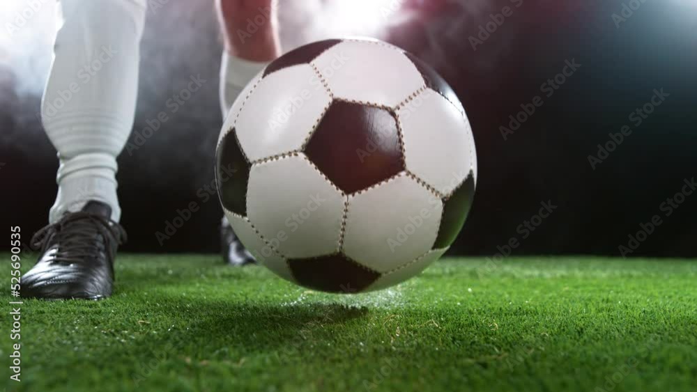 Close-up of Football Player Kicking Soccer Ball, Super Slow Motion at 1000 fps. Filmed on High Speed Cinematic Camera.