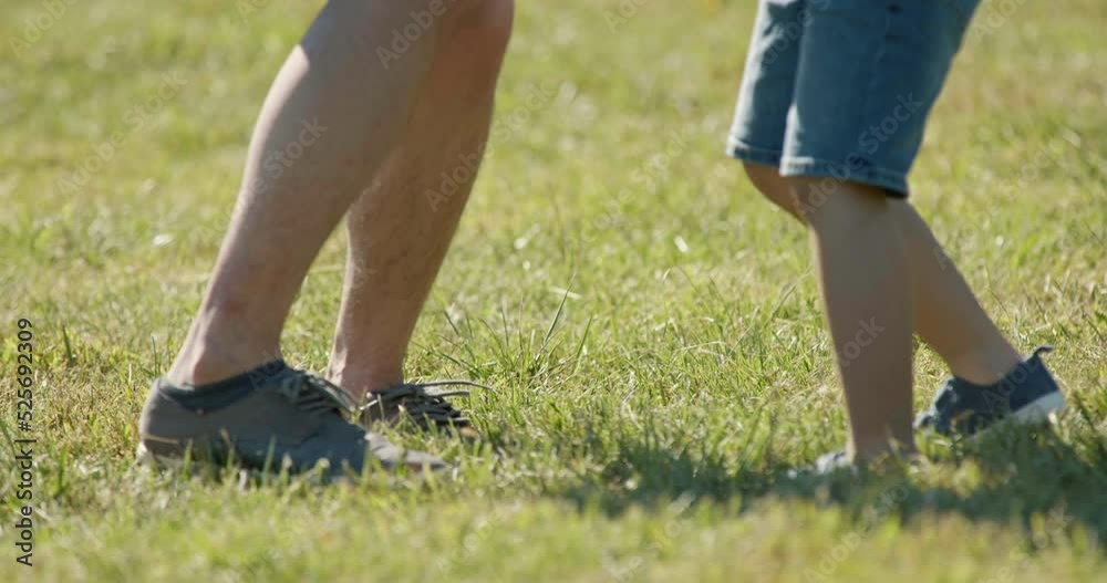 Happy father and son playing football in park,4K Happy father and son playing football in park,4K
