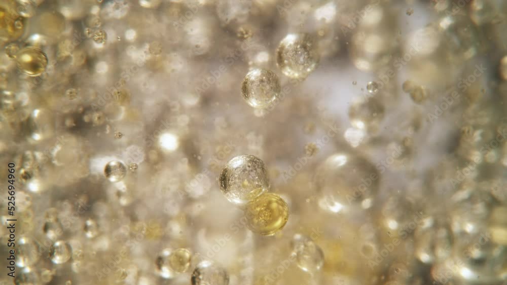 Super Slow Motion Shot of Oil Bubbles on Golden Background at 1000fps. Shoot on high speed cinema camera. Super Slow Motion Shot of Oil Bubbles on Golden Background at 1000fps. Shoot on high speed cinema camera.