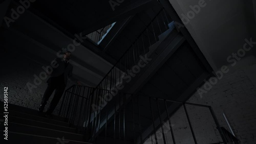 Multi storey office building. Business man in formal attire descends the stairwell the lower floor. Business center. Residential building, apartments, staircase between floors that leads parking lot