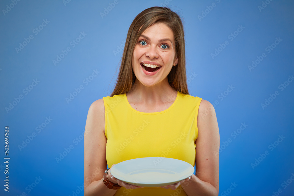 Smiling young lady in yellow dress holding empty white plate. isolated female portrait. Smiling young lady in yellow dress holding empty white plate. isolated female portrait.