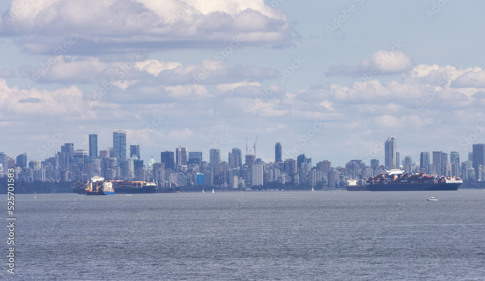 Downtown City Skyline with Industrial Cargo Ships. Sunny Cloudy Day. Vancouver, British Columbia, Canada. Downtown City Skyline with Industrial Cargo Ships. Sunny Cloudy Day. Vancouver, British Columbia, Canada.