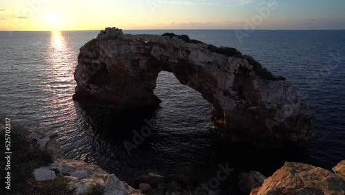Time-lapse of a seascape with the natural arch Mirador Es Pontas in Mallorca, Spain photo