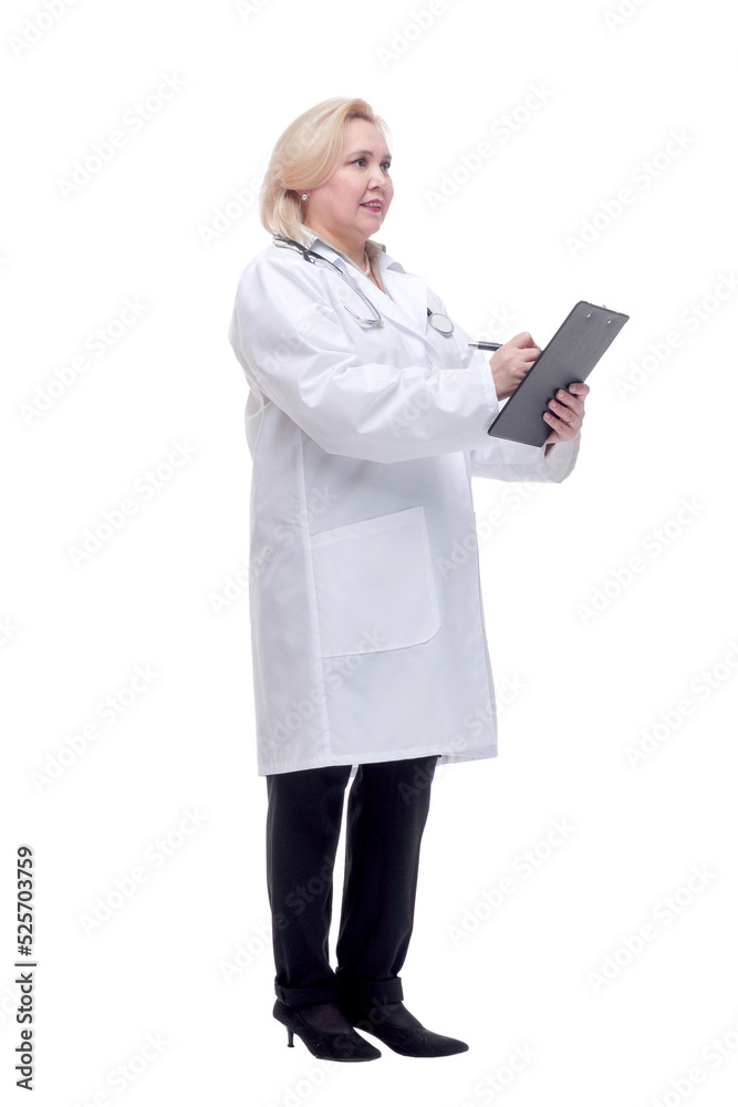 Profile of a pretty doctor with white lab coat, stethoscope smiling and writing notes in clipboard Profile of a pretty doctor with white lab coat, stethoscope smiling and writing notes in clipboard