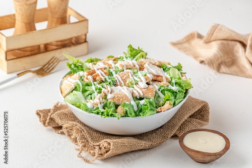 Obraz na plátně Fresh healthy caesar salad in a bowl