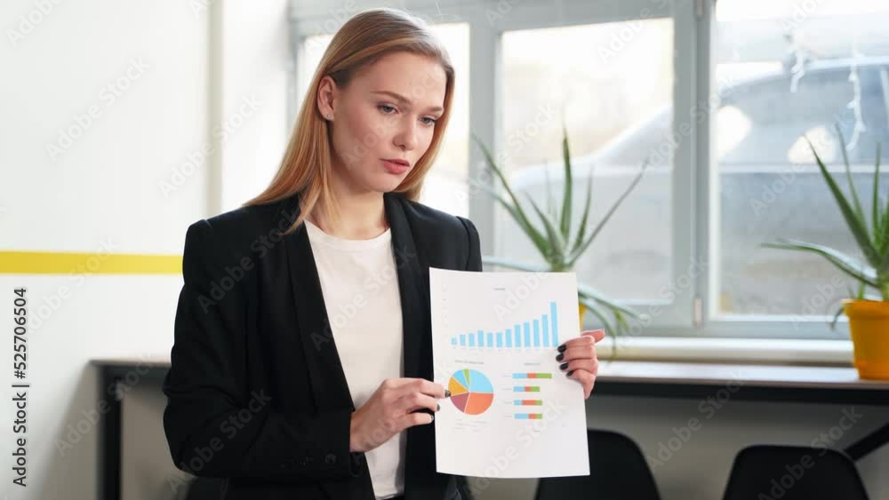 Business woman presents report, shows diagrams, charts in conference room for multiethnic partners. Diverse international team listen CEO on briefing meeting in office. Corporate people discuss plan. Business woman presents report, shows diagrams, charts in conference room for multiethnic partners. Diverse international team listen CEO on briefing meeting in office. Corporate people discuss plan.