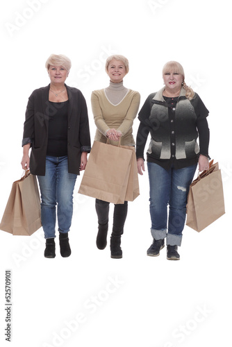 in full growth. three happy women with shopping bags.