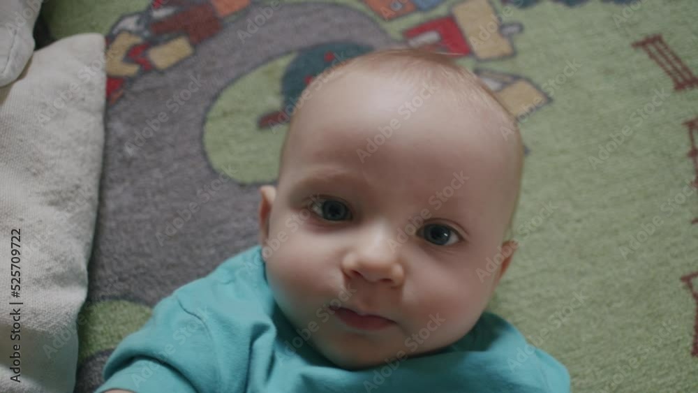 Adorable newborn looking into camera. Infant with blue eyes tries to get the camera. Adorable newborn looking into camera. Infant with blue eyes tries to get the camera.