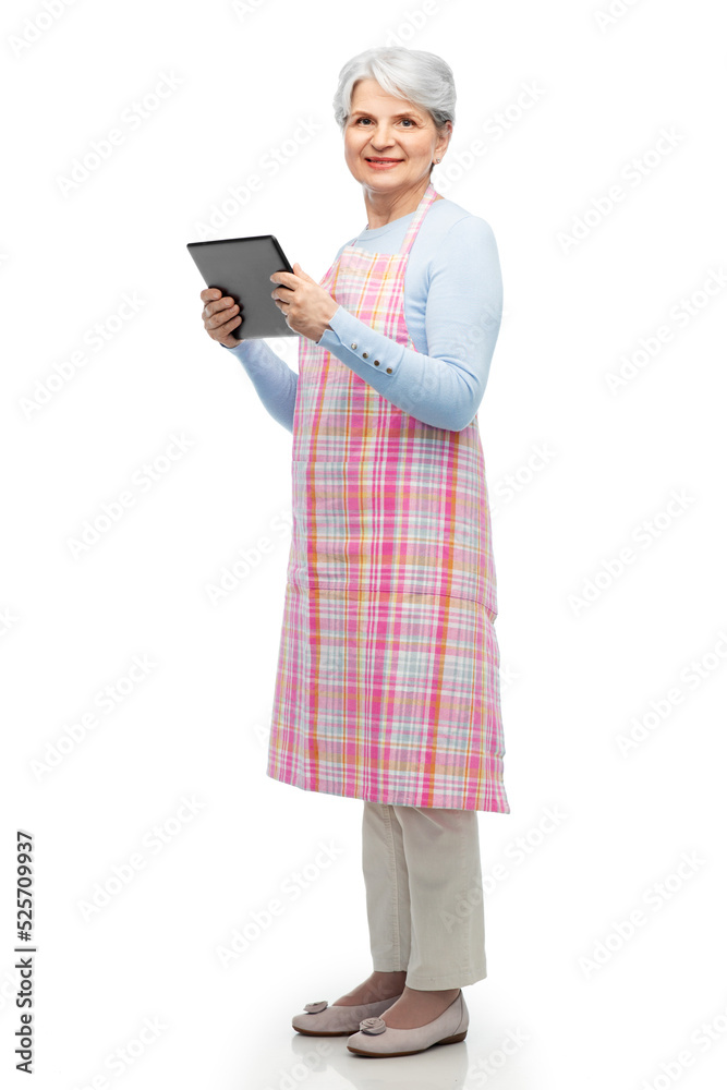 cooking, culinary and old people concept - happy smiling senior woman in kitchen apron with tablet pc computer over white background cooking, culinary and old people concept - happy smiling senior woman in kitchen apron with tablet pc computer over white background