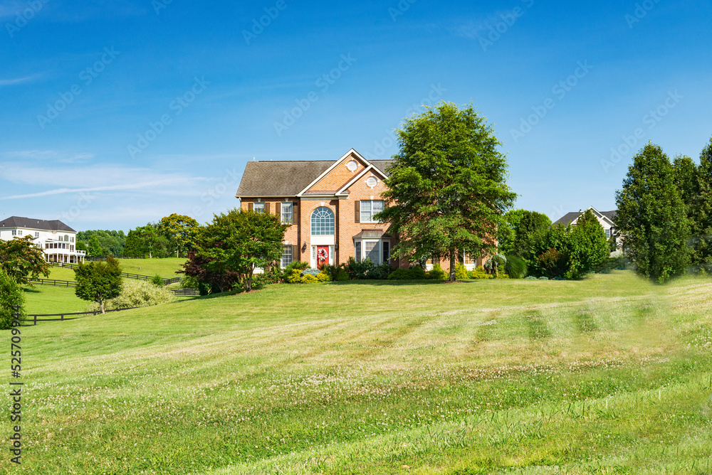 Landscape with a large country house. Large mowed lawn and blue sky. Landscape with a large country house. Large mowed lawn and blue sky.