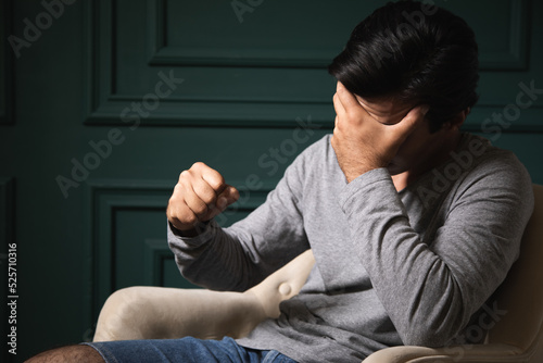 angry man sitting in armchair