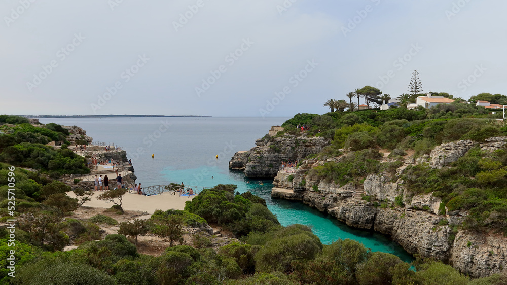 Cala en Brut beach, Menorca (Minorca), Spain. Lovely bay and beach Cala'n Brut. Popular place to jump into water from rock shelves
