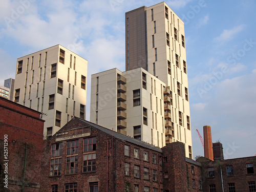 modern highrise apartment developments behind old abandoned industrial buildings in manchester city centre