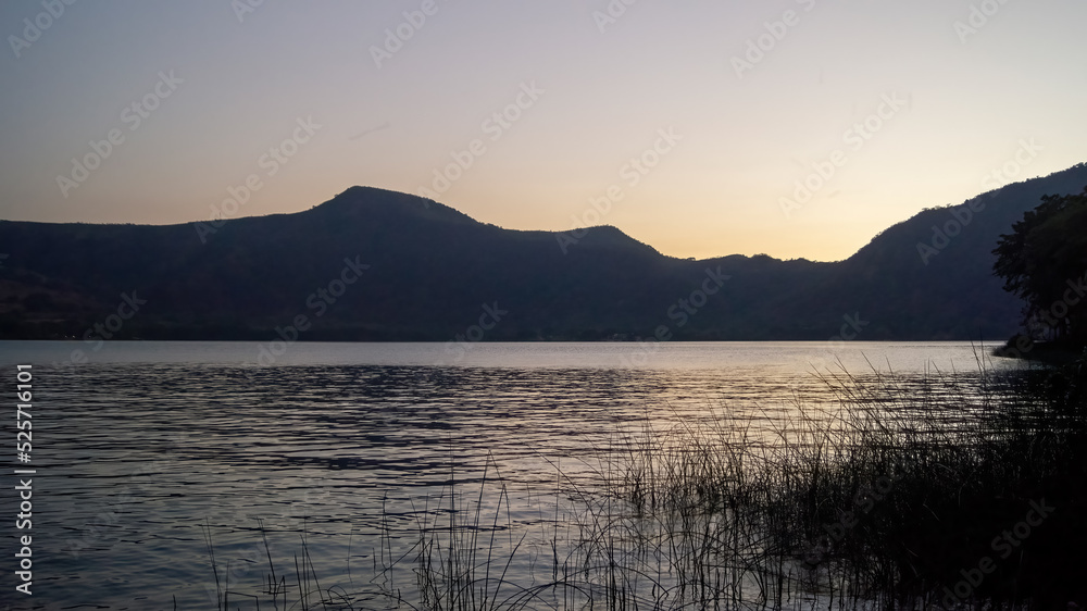 lake of chapala, jalisco mexico, lake at sunset with fishing boats, sun reflection on the lake, mexico