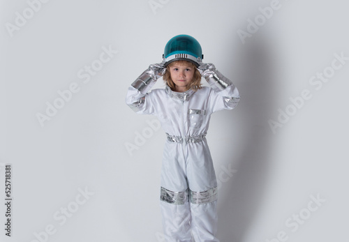 Little boy astronaut in space suit holding helmet. Success, creative and start up concept.