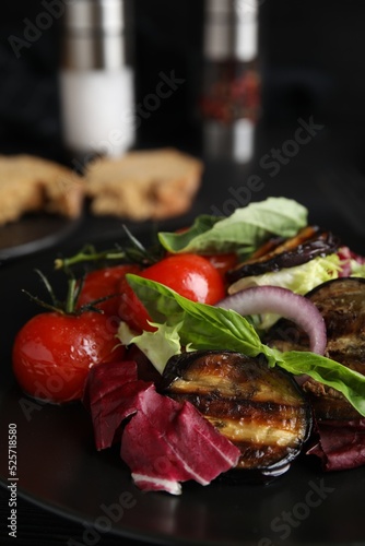 Fototapeta Naklejka Na Ścianę i Meble -  Delicious salad with roasted eggplant and basil on plate, closeup