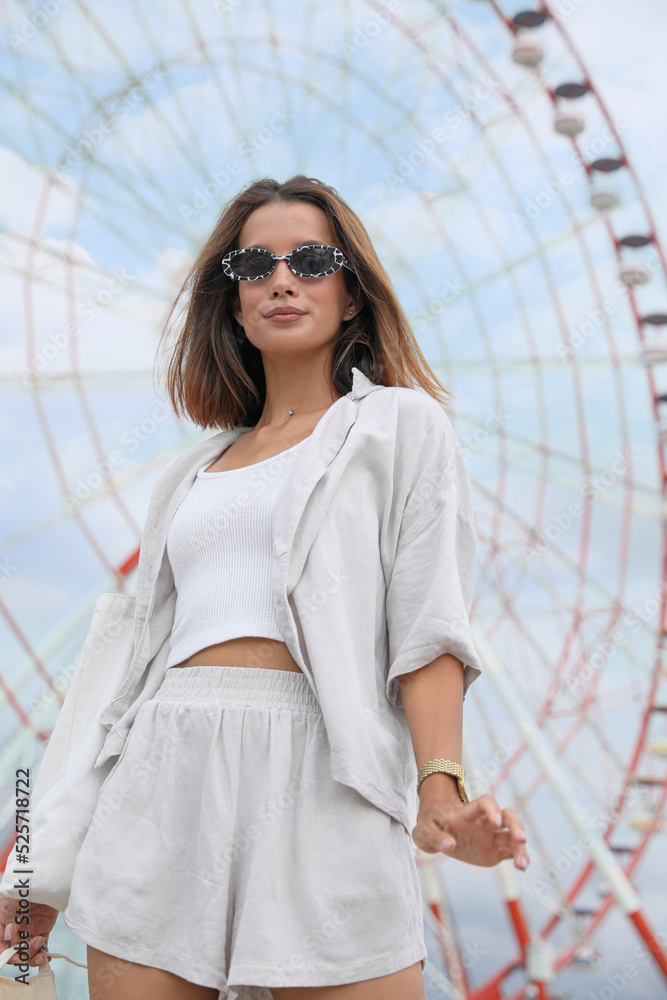 Beautiful young woman near Ferris wheel outdoors Beautiful young woman near Ferris wheel outdoors