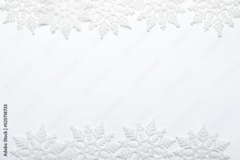 Fototapeta premium Beautiful decorative snowflakes on white background, flat lay. Space for text