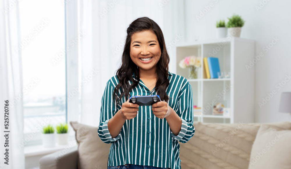 people, leisure and gaming concept - happy woman playing video game with gamepad over home background people, leisure and gaming concept - happy woman playing video game with gamepad over home background