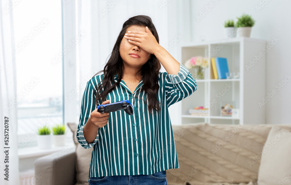 people, leisure and gaming concept - upset woman playing video game with gamepad over home background people, leisure and gaming concept - upset woman playing video game with gamepad over home background