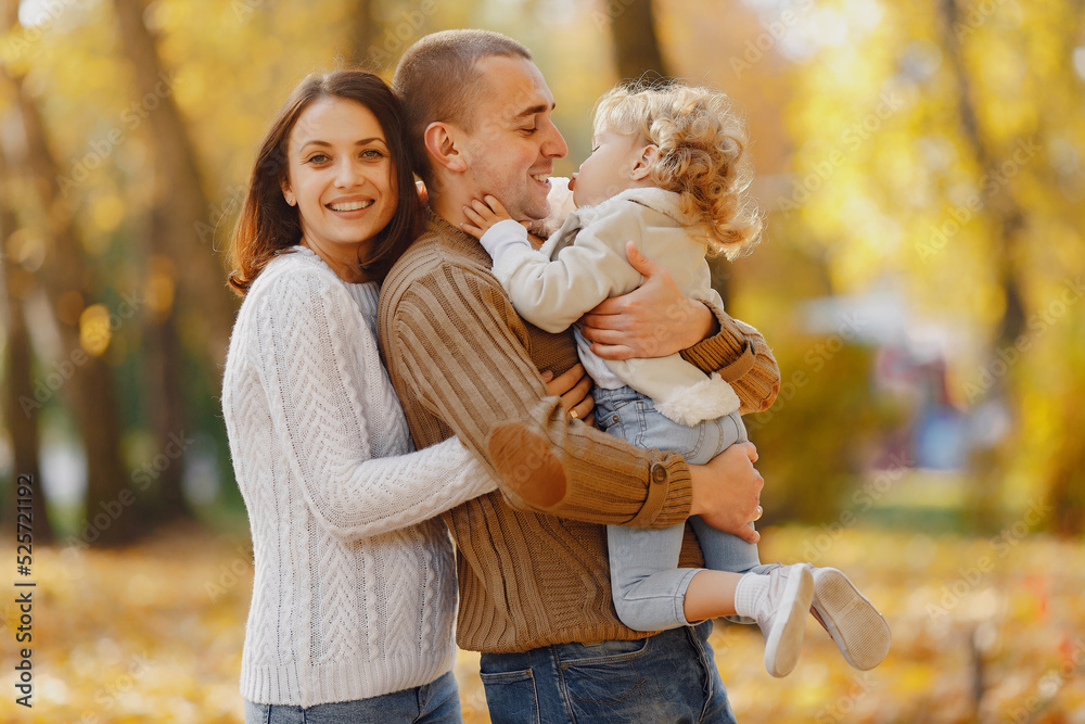 Cute and stylish family playing in a autumn field Cute and stylish family playing in a autumn field