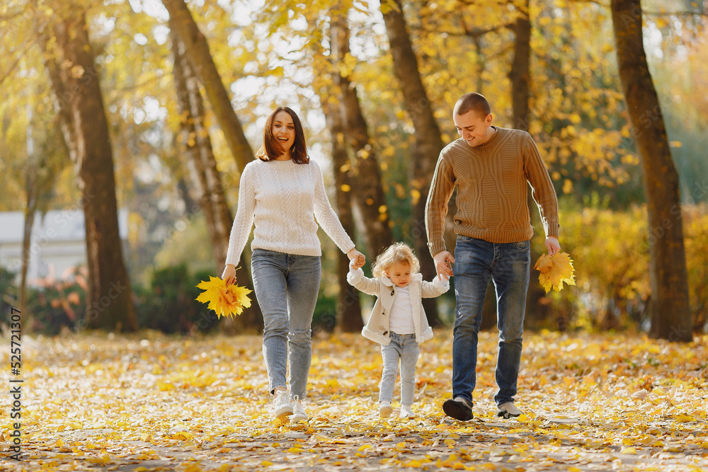 Fototapeta premium Cute and stylish family playing in a autumn field
