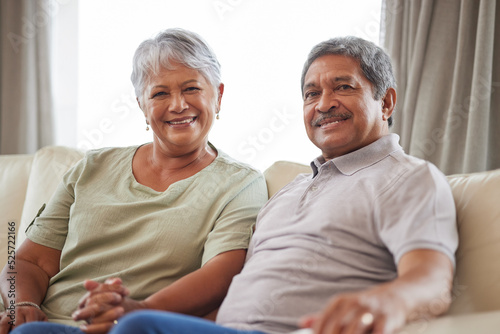 Love, smile and senior couple on living room interior sofa relax and lounge together at home portrait. Face of happy people, man and woman smile while living retirement lifestyle at family house