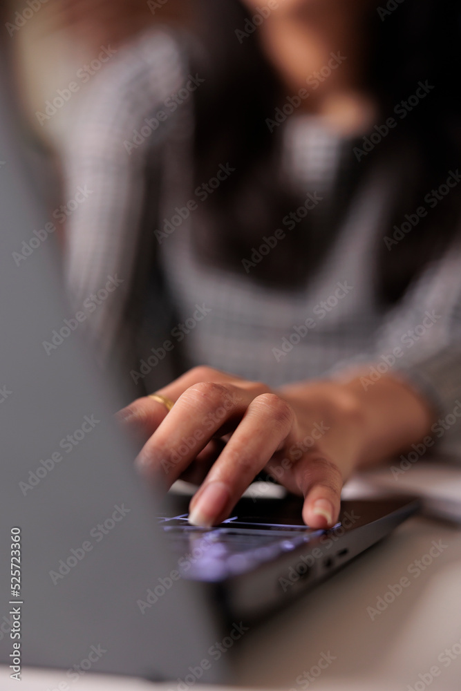 Young adult typing information on laptop, searching report and sending professional email. Using computer to search online data and browse internet network, taking notes and learning. Close up. Young adult typing information on laptop, searching report and sending professional email. Using computer to search online data and browse internet network, taking notes and learning. Close up.