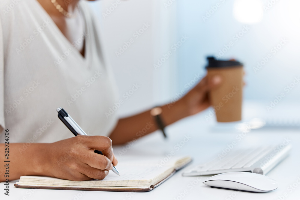 A business woman writing notes in a notebook or managing her schedule in a diary or completing a journal in an office. Closeup of an assistant working on a notepad learning from the internet A business woman writing notes in a notebook or managing her schedule in a diary or completing a journal in an office. Closeup of an assistant working on a notepad learning from the internet