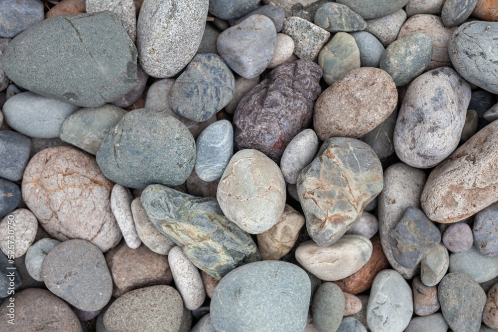 Large stones of different shapes on the riverbank close-up. there are a lot of small stones nearby. Large stones of different shapes on the riverbank close-up. there are a lot of small stones nearby.