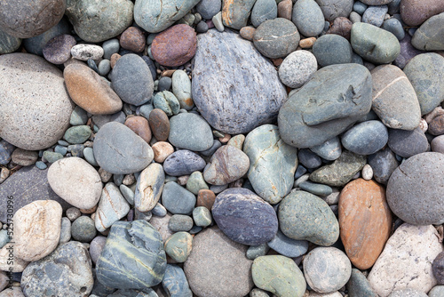 Large stones of different shapes on the riverbank close-up. there are a lot of small stones nearby.