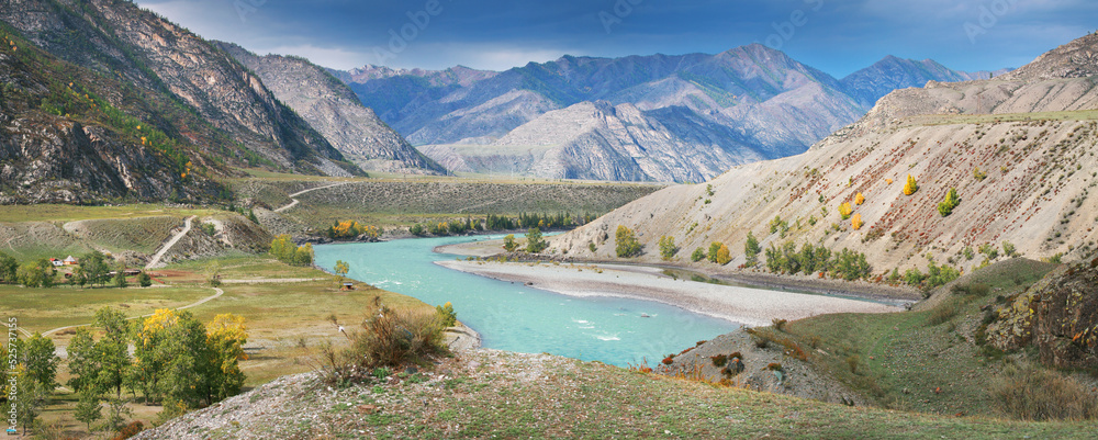 Fototapeta premium Katun river valley, light on the hillsides and stormy sky, panoramic view