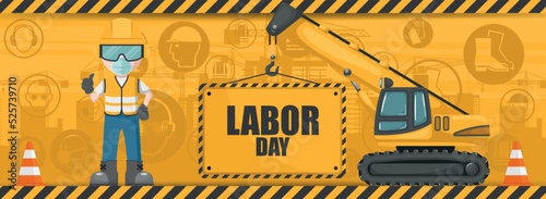 Industrial labor day background with telescopic crawler crane carrying a sign and worker in his personal protective equipment