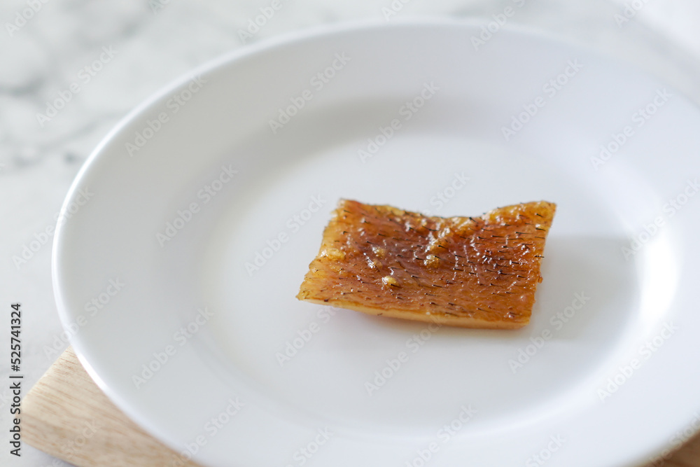 Fried pork skin on a white plate. Pig food culinary cuisine. Fried pork skin on a white plate. Pig food culinary cuisine.